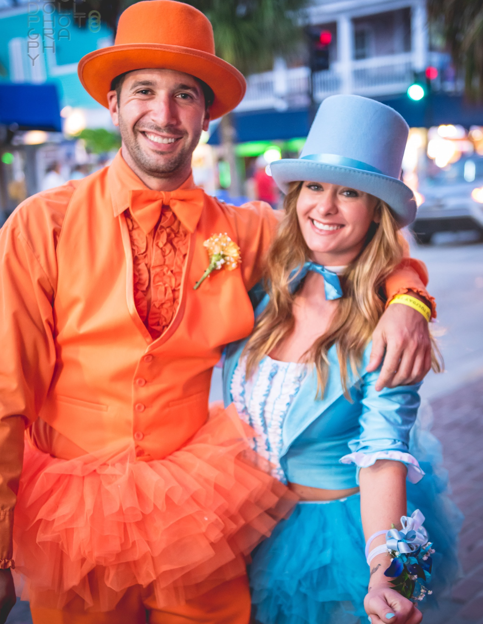 Male and female couple smiling at Fantasy Fest in their Dumb and Dumber themed costumes with tutus.