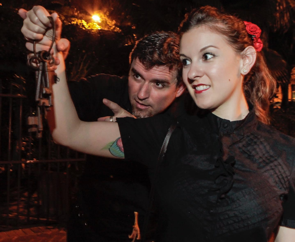 Man and woman hold up set of old-style keys while on a Haunted Key West Tour.