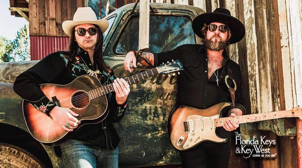 The Allman Betts Band & JD Simo posing with their guitars, sunglasses and cowboy hats.