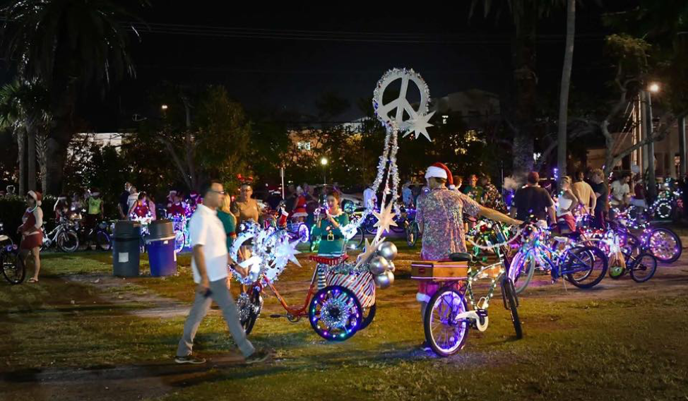 Night-time shot of participants with their decorated bicycles for the Lighted Bike Parade.