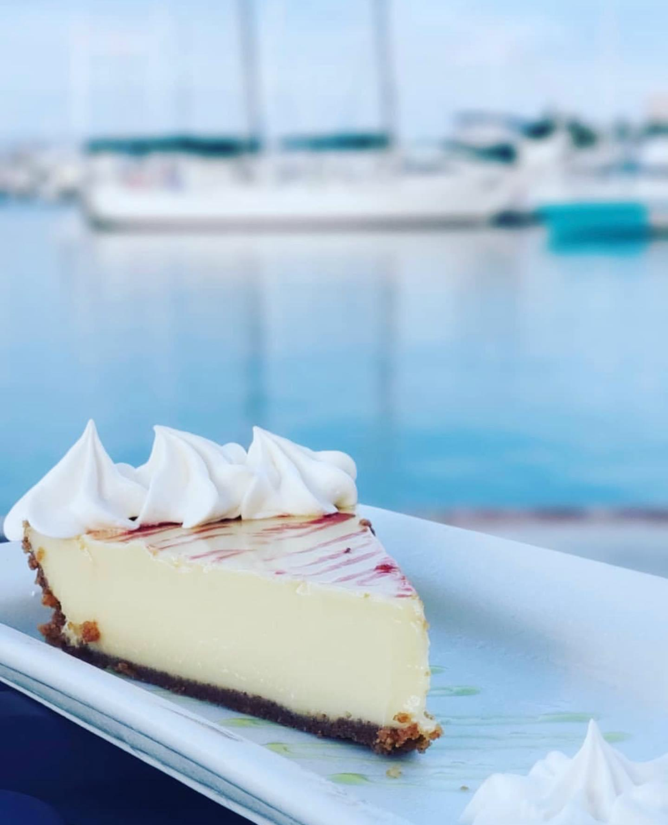 Key Lime Pie on a plate in front of a harbour