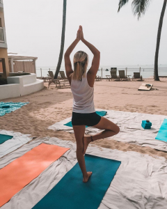 Woman doing yoga on the beach