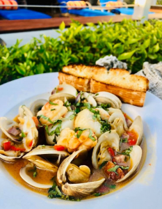 Sautéed shrimp, scallops clams chorizo and red peppers in a garlic wine broth with a side of grilled focaccia bread - one of the specials at Southernmost Beach Cafe