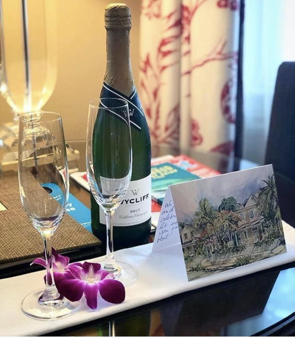 Bottle of sparkling with two glasses and card