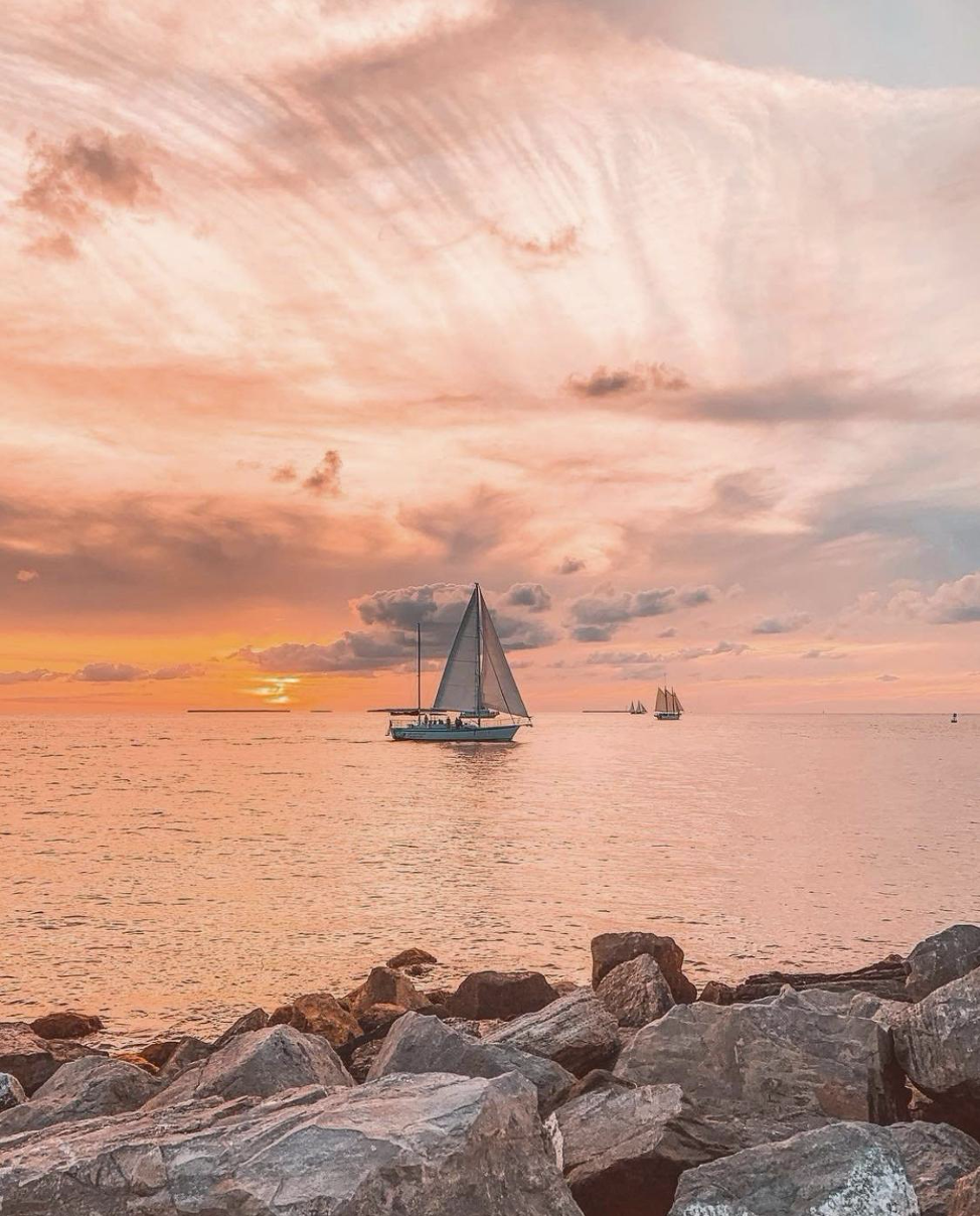 Ocean sunset with sailboat