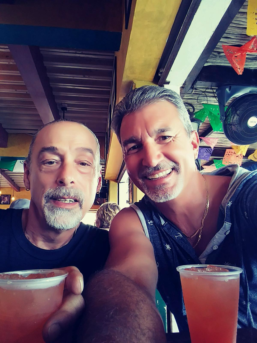 Todd Jones and male guest sharing a drink at Southernmost Beach Resort