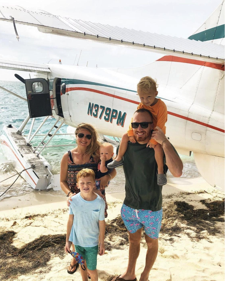 Family in front of a sea plan on Key West beach