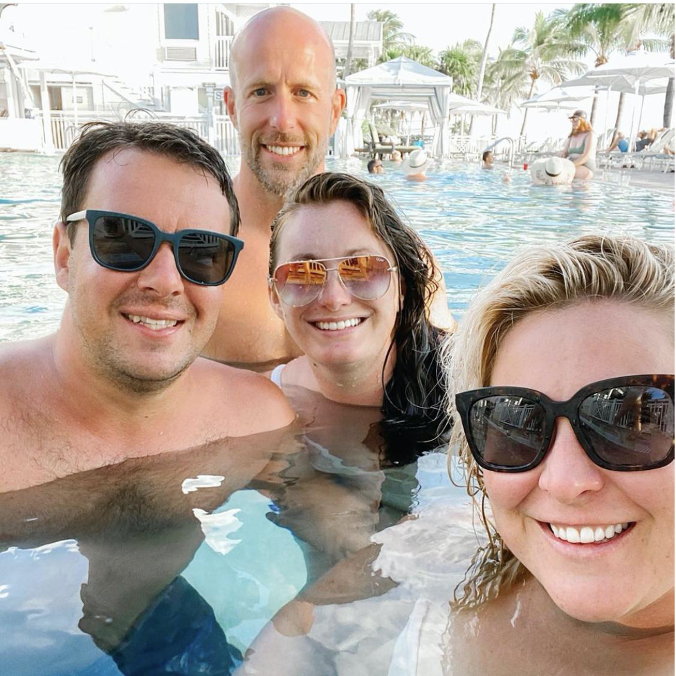 Group of friends selfie pool side.