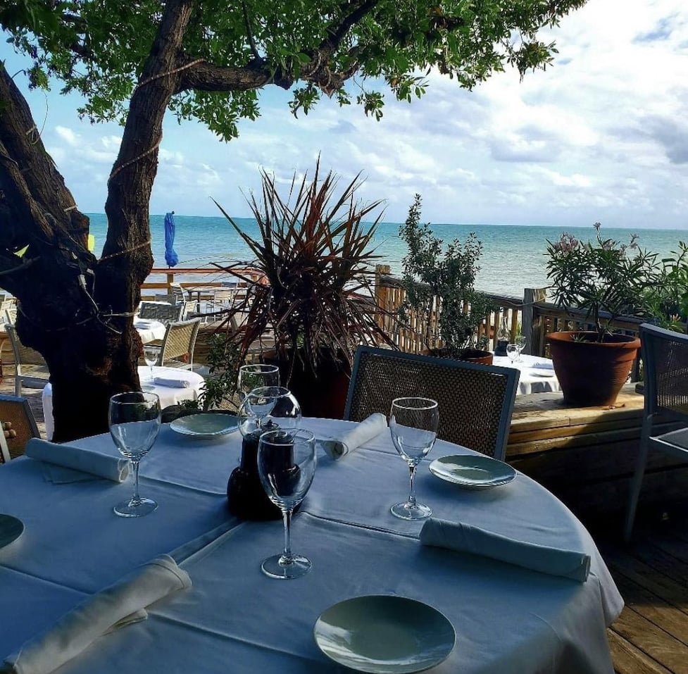 Beautifully set table overlooking a very blue Atlantic Ocean