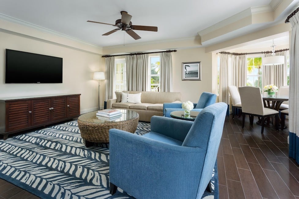 A bright and nautical themed living area with navy blue couch