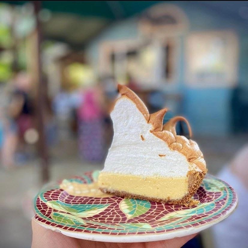 Fluffy slice of lemon meringue pie on a colorful plate.