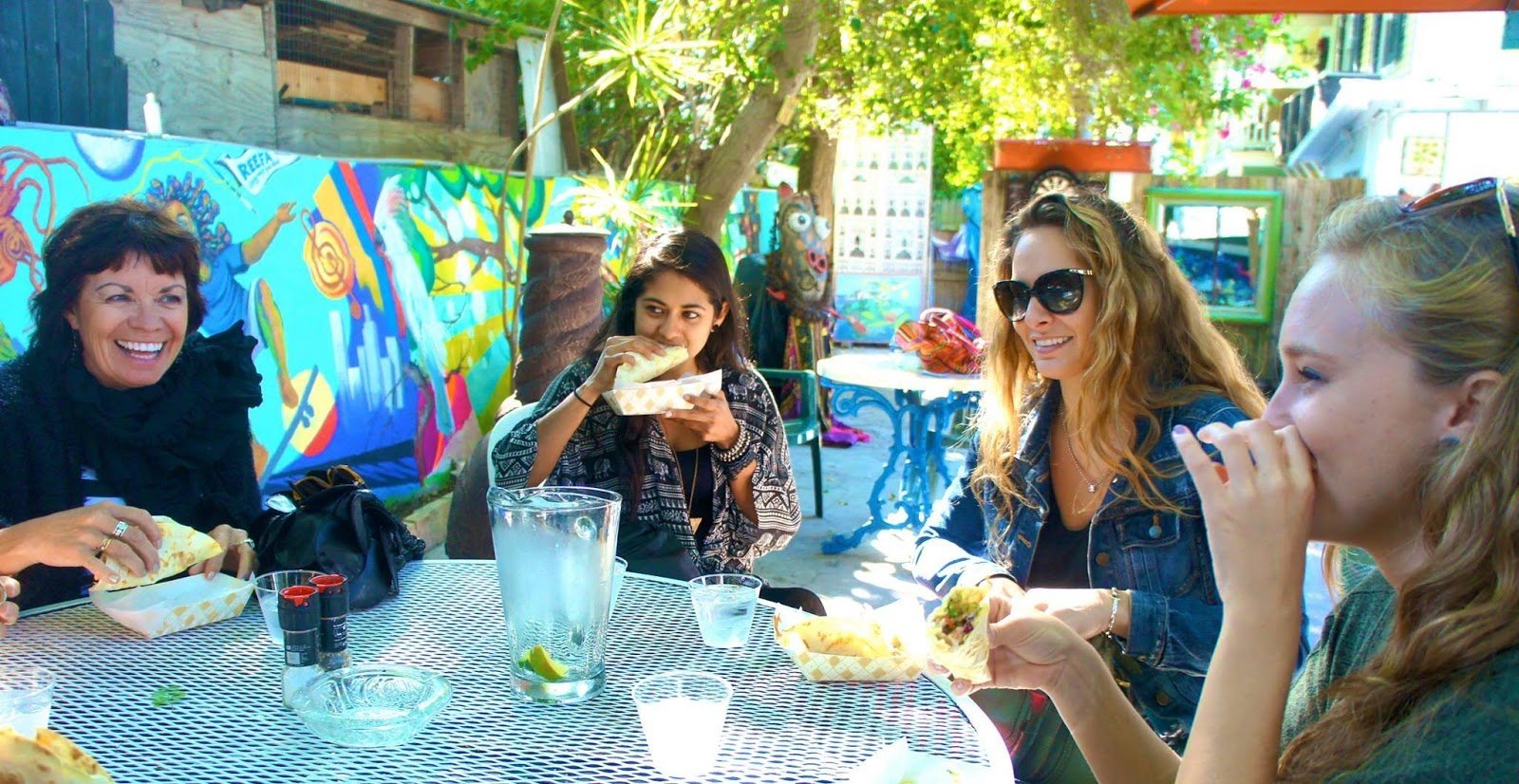 A group of women enjoying drinks and a meal together