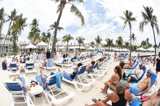 Many people on beach chairs enjoying a show