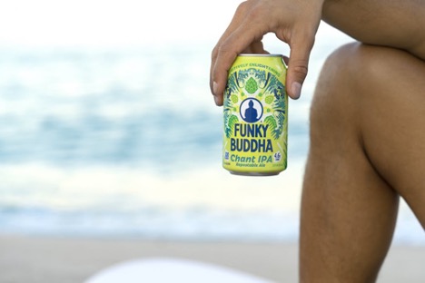 beer by the beach in someone's hand