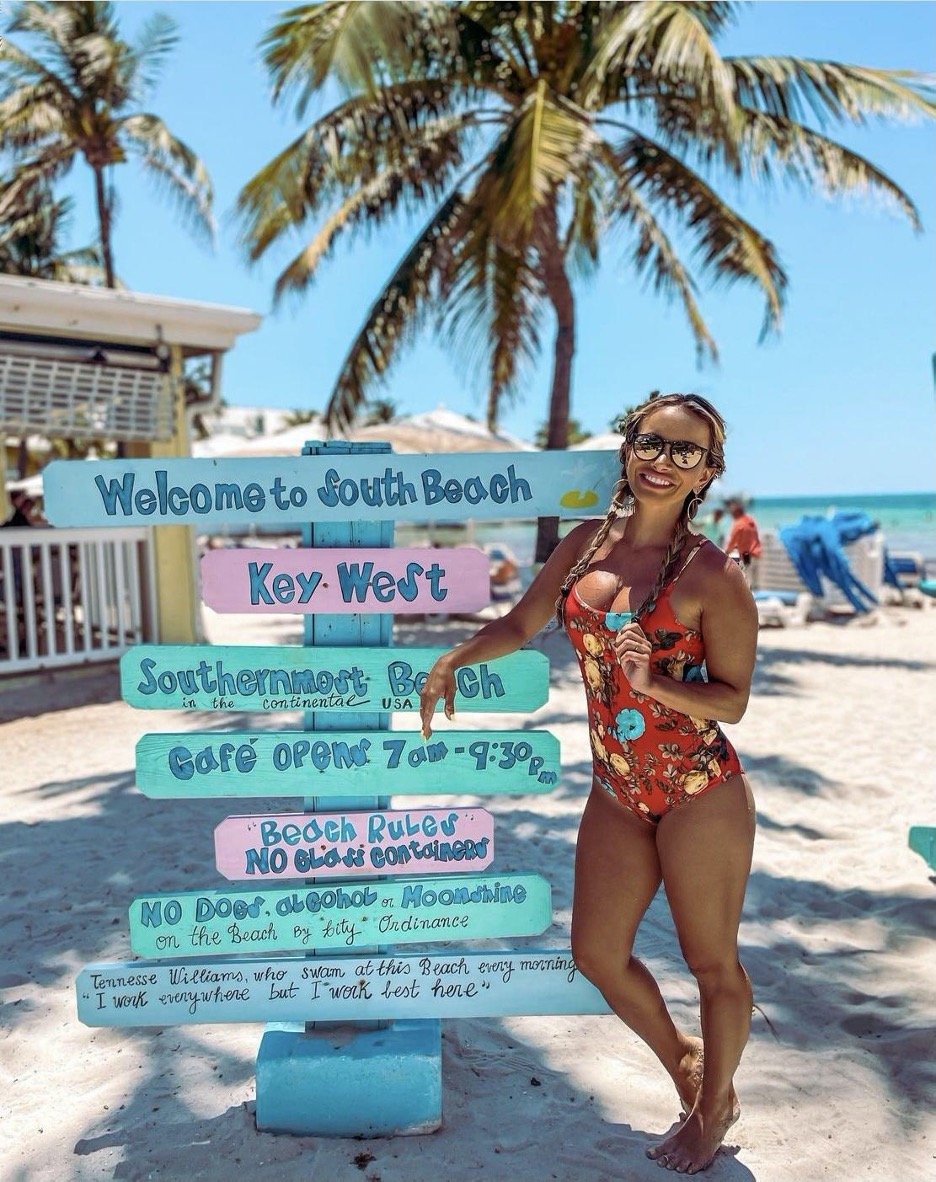 woman next to beach signs