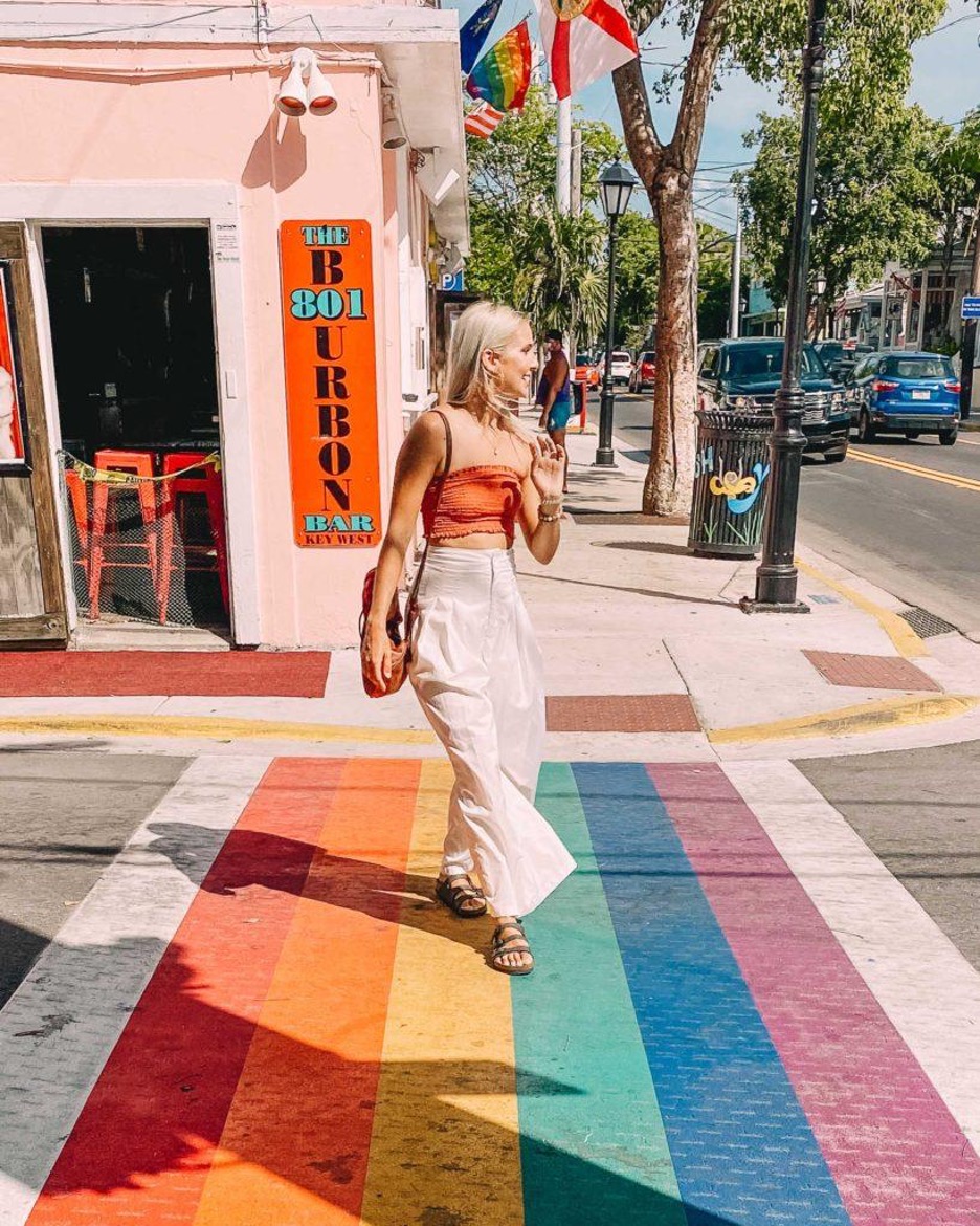 woman walking on a rainbow sidewalk