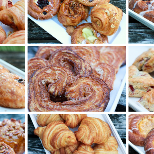 Various pastries, including croissants, danishes, and scones, are displayed on white trays. They feature toppings like chocolate, nuts, fruit, and sugar. The setting is outdoors on wooden surfaces in Key West.