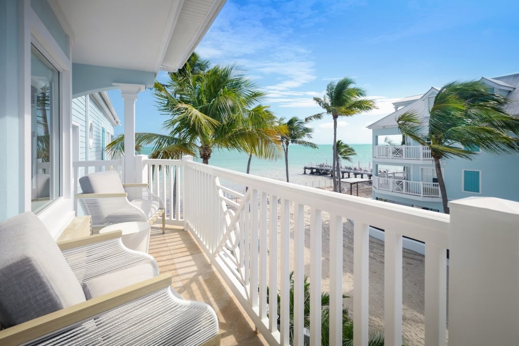 Key West Beach Resort room with balcony view to Florida's ocean and palm trees