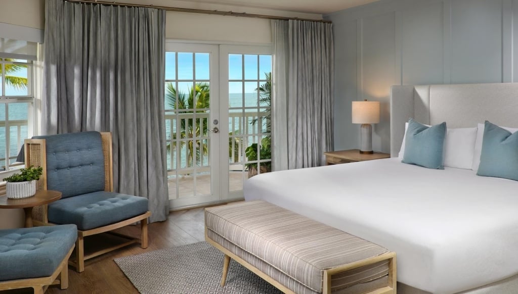 Southernmost Beach Resort luxurious ocean-view suite featuring a king bed, offering a serene and breathtaking ambiance.;Key West: A Guide to the Most Memorable Romantic Getaway; Romantic getaway to Key West, Floda; Romantic places to stay in Key West on the beach