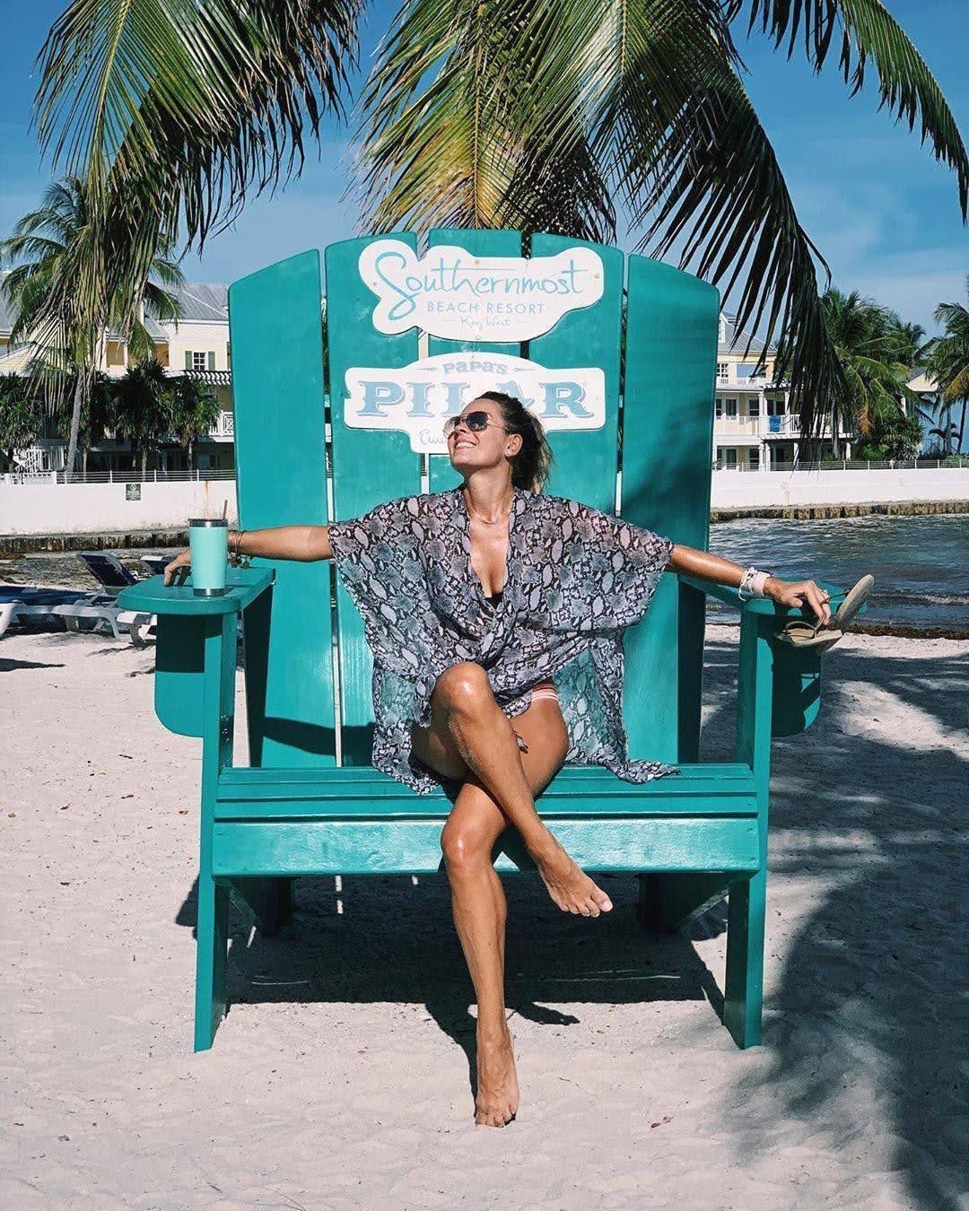 Woman sitting in big beach chair