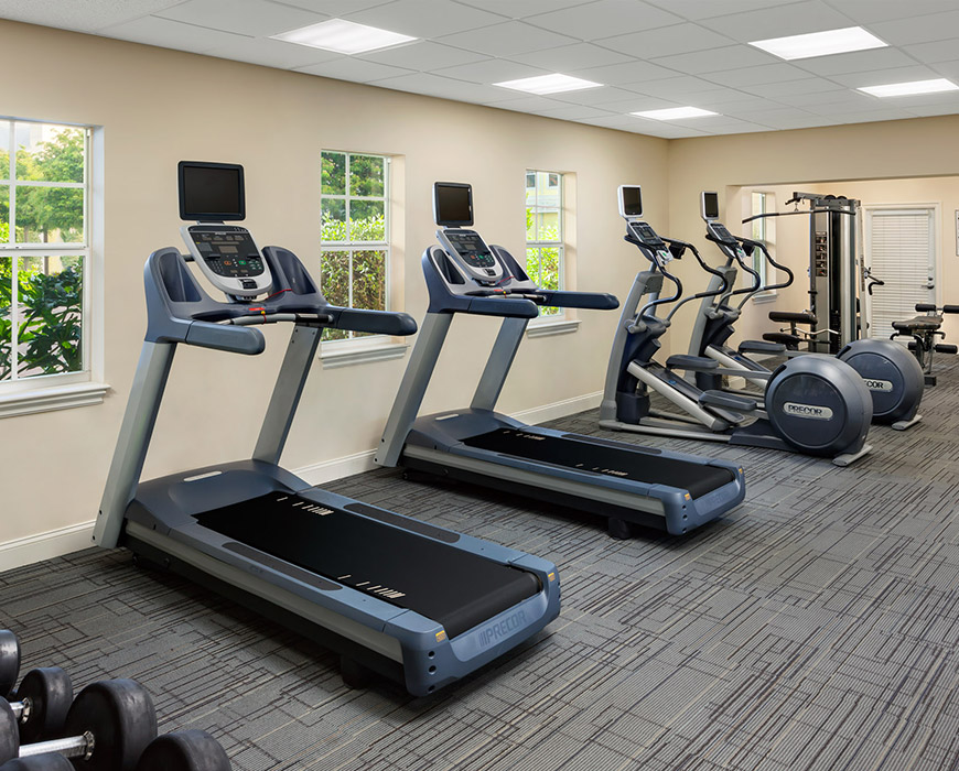a gym with treadmills and exercise equipment