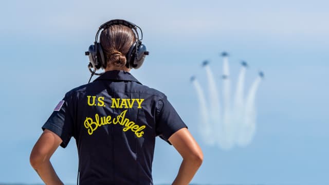 woman guiding Blue Angels