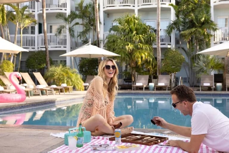 couple by the pool laughing