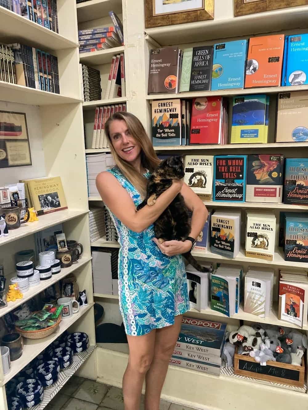 woman holding cat in book store