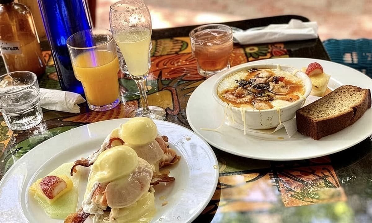 eggs benedict and other breakfast items on table