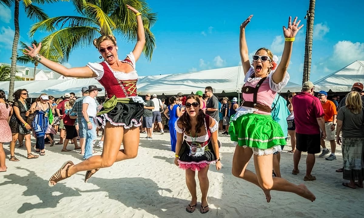 Three women wearing traditional German dirndl dresses