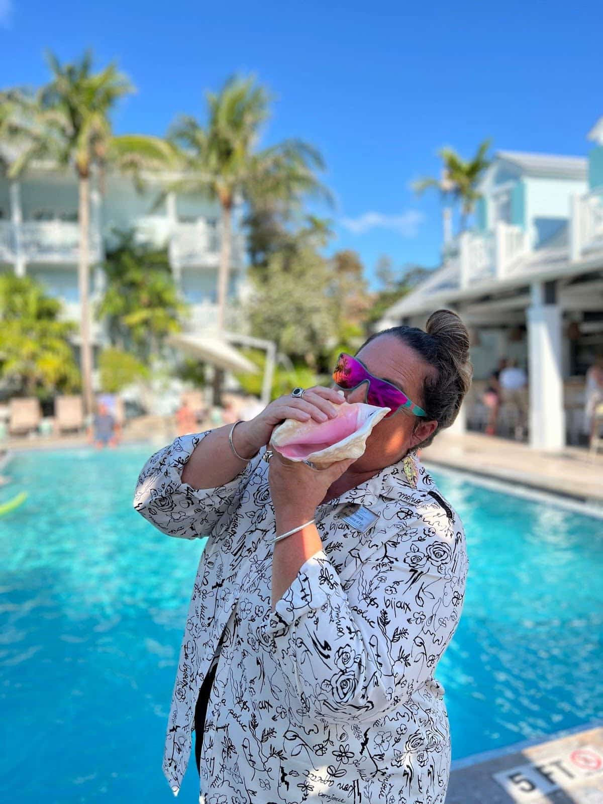 woman blowing conch shell