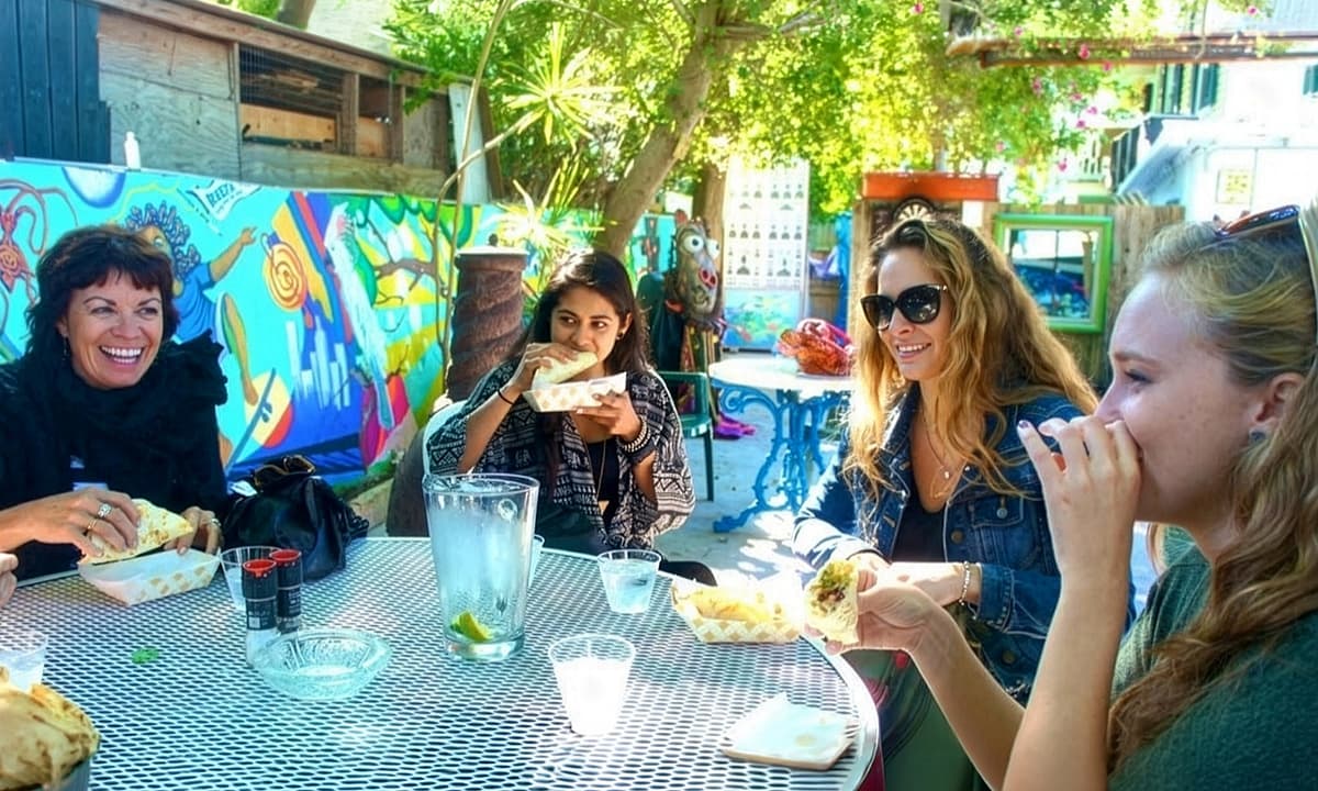 A group of women enjoying drinks and a meal together