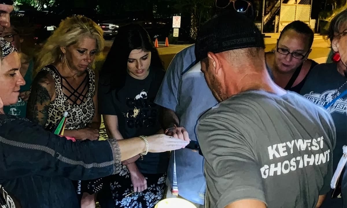 A group of people and their Haunted Key West tour guide