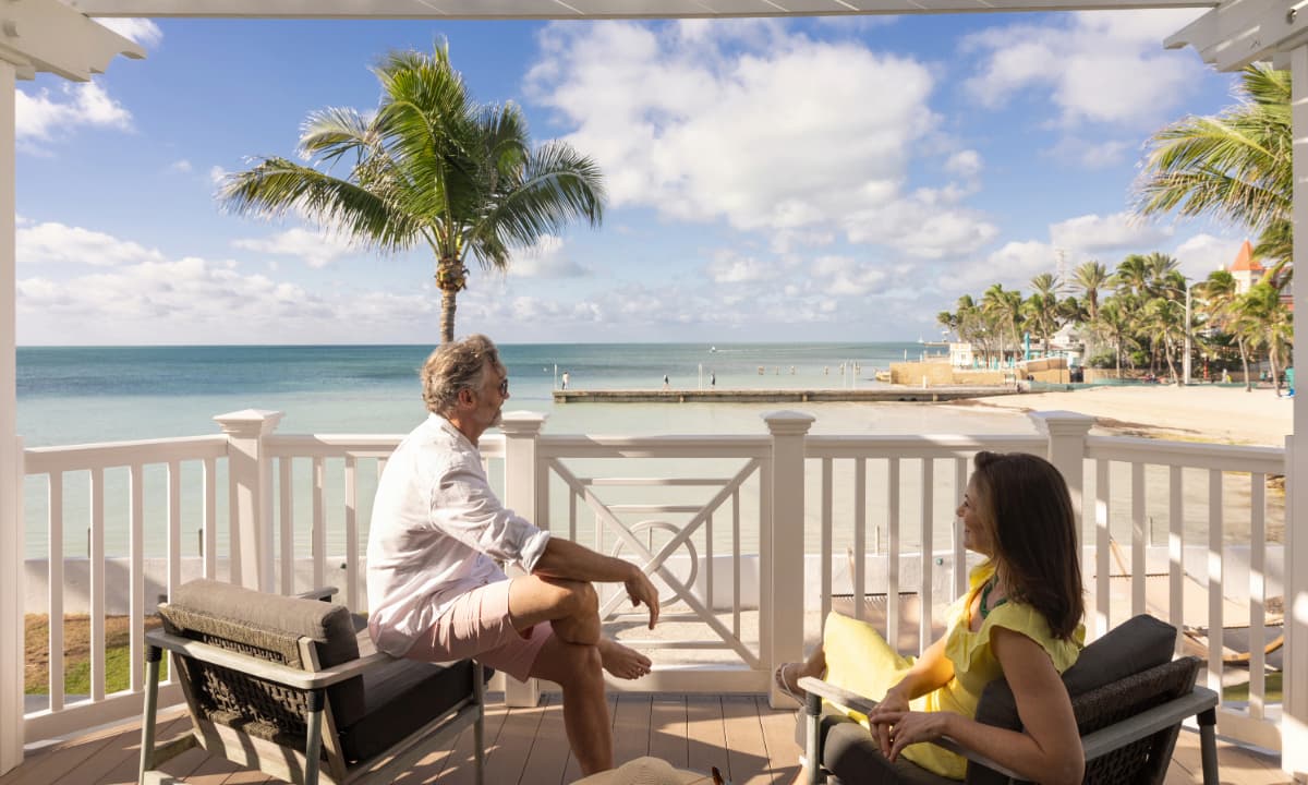 couple on balcony by beach