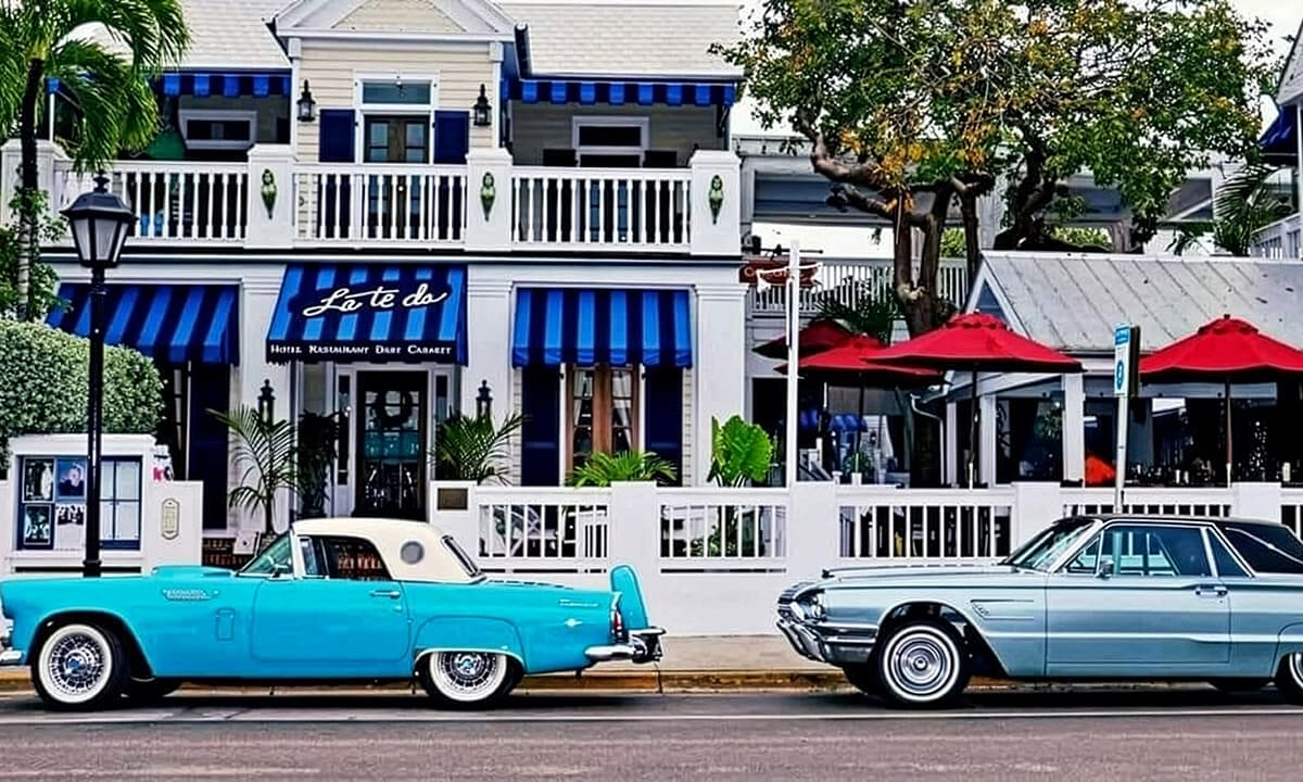 Two vintage cars parked on the street