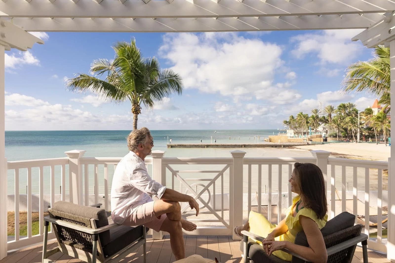 people on a balcony looking at the beach