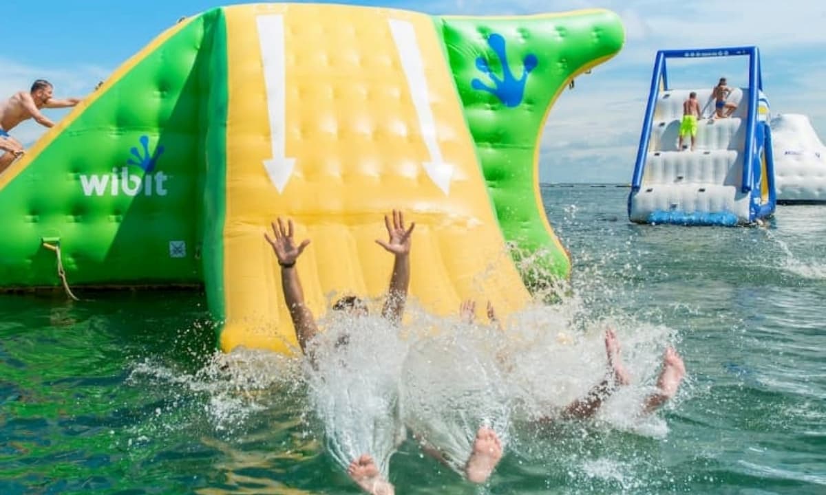 family playing on water playground