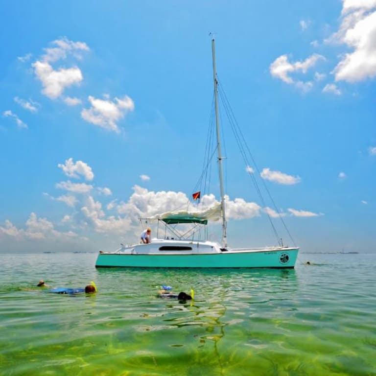sail boat and people snorkeling