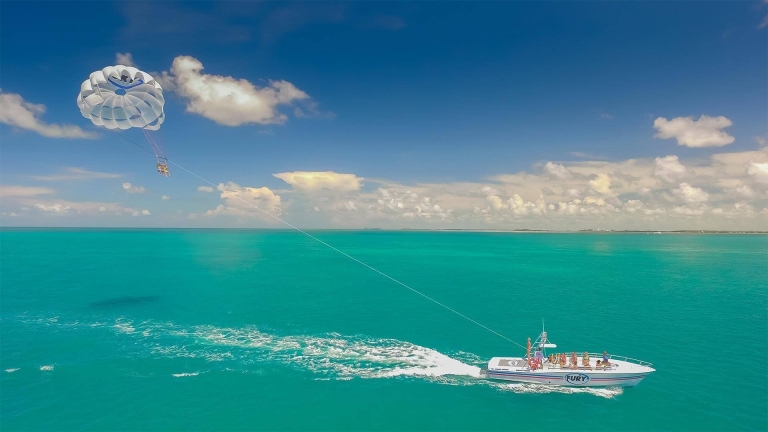 boat pulling parasailing couple