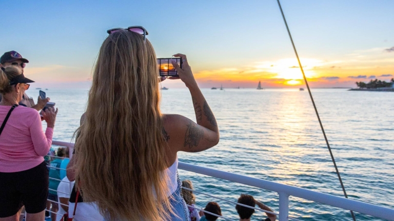 woman taking photo from boat