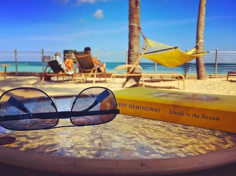 glasses and Ernest Hemingway book on table
