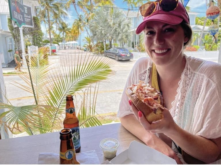 woman eating lobster roll