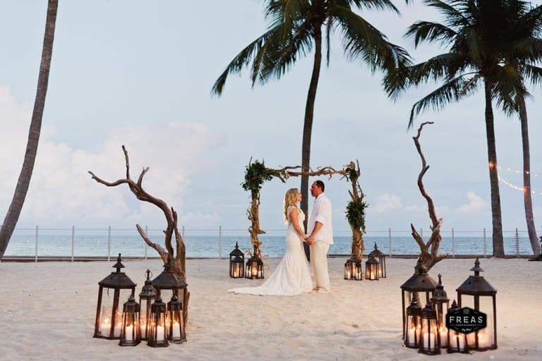 couple holding hands at altar