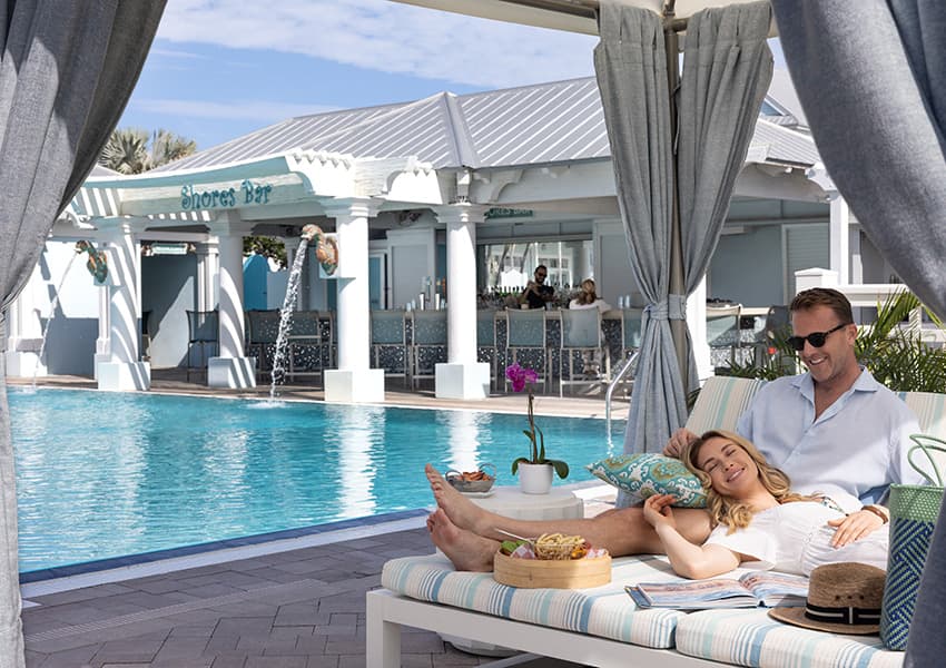 A couple lounging in the pool cabana