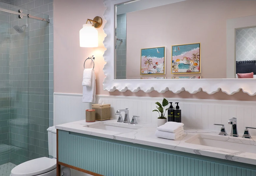 A clean and stylish bathroom with a double vanity, shower, and toilet.